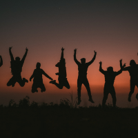 silhouette of people jumping 